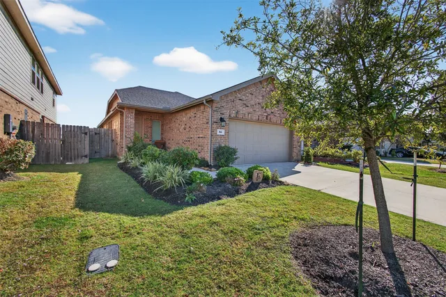 a view of a house with a yard and plants