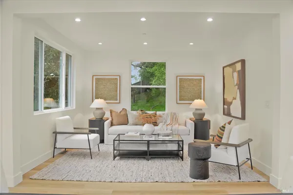 a living room with furniture rug and window