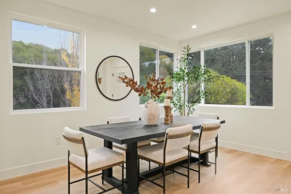 a dining room with furniture and a window
