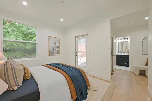 a bedroom with a bed and glass door