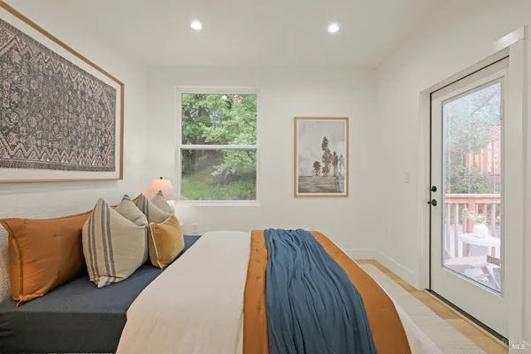 a bed sitting in a bedroom next to a window