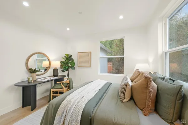 a bedroom with a bed and a large window