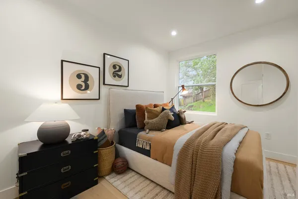 a bed room with a bed and painting on the wall