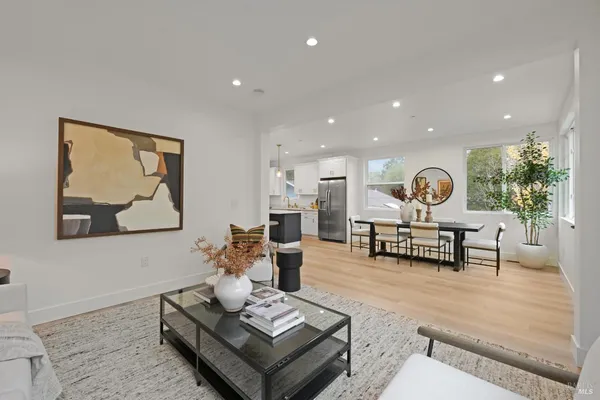 a living room with furniture and paintings on the wall