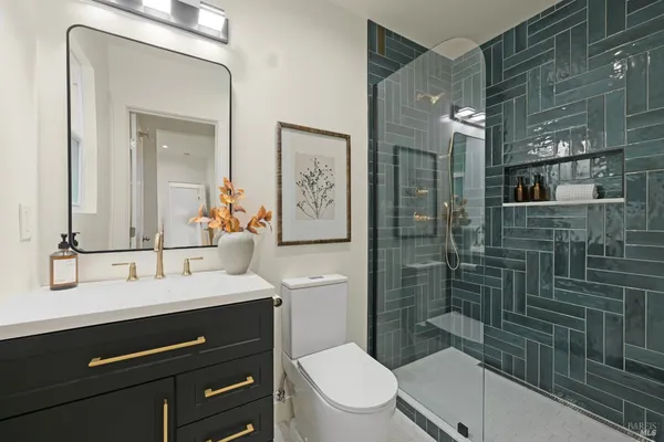 a bathroom with a sink a toilet and shower