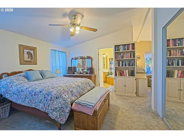 a bed room with a bed and a book shelf