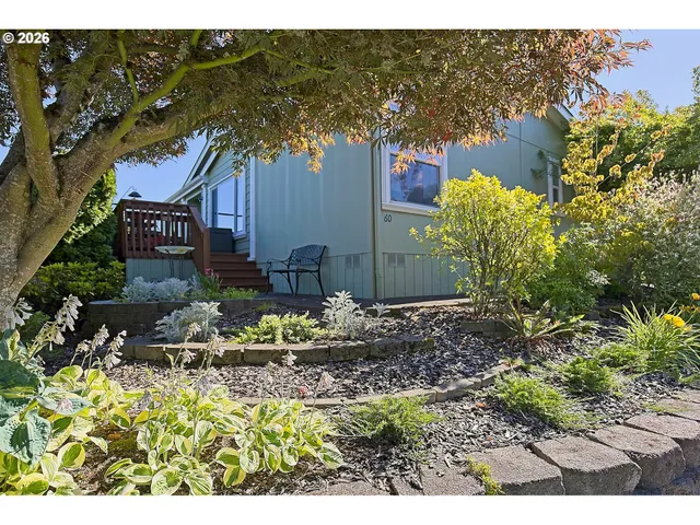 a front view of a house with a yard and sitting area