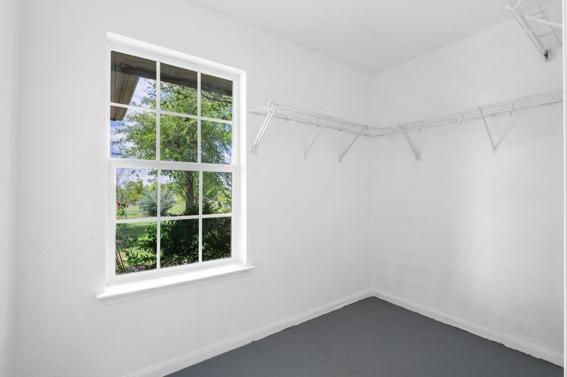 14325 South Turnersville Road Buda, TX 78610 - Photo 18 of 35 Large, walk in closet off of primary bedroom has a window bringing in natural light