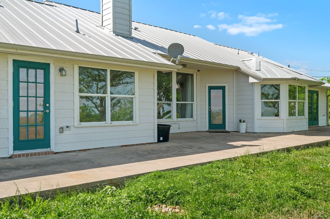 14325 South Turnersville Road Buda, TX 78610 - Photo 24 of 35 Back of house featuring an expansive patio, perfect for watching sunsets over the ten acres