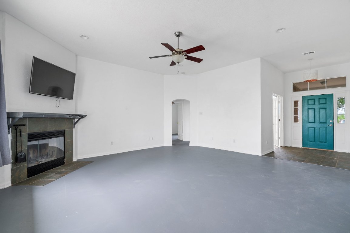 14325 South Turnersville Road Buda, TX 78610 - Photo 5 of 35 Expansive living room has painted concrete floors, wood burning fire place and fresh interior paint