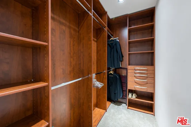 a spacious bedroom with a bed and a window