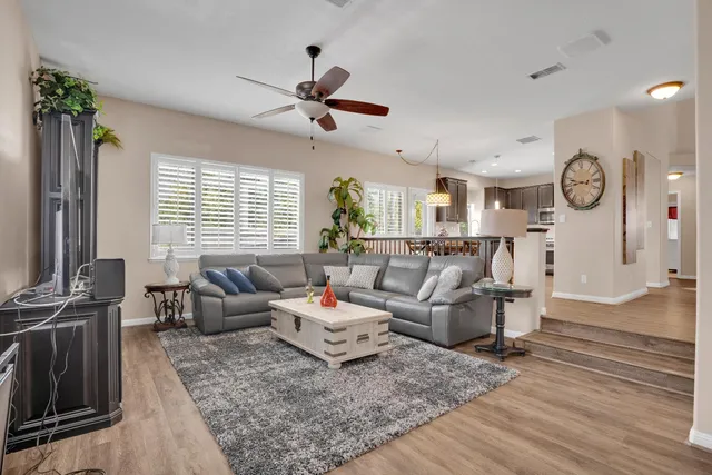 a living room with furniture and wooden floor