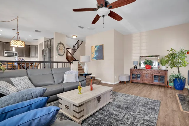 a living room with furniture and a chandelier