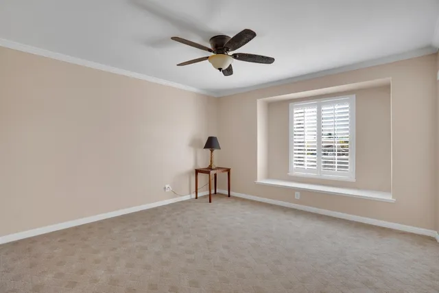 a view of a livingroom with a ceiling fan and window