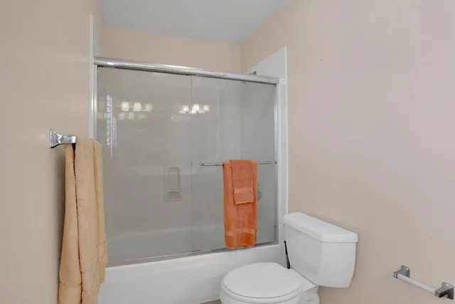 a bathroom with a shower and toilet