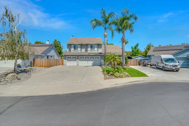 a front view of a house with a yard and a garage