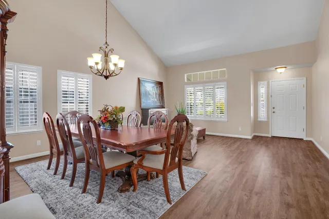 a view of a dining room with furniture wooden floor and chandelier