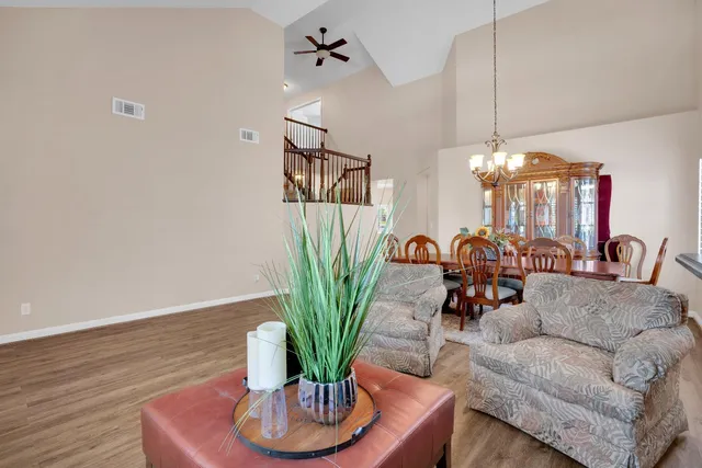 a living room with furniture potted plant and a chandelier