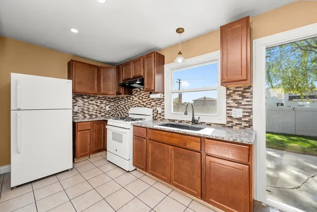 a kitchen with stainless steel appliances granite countertop a refrigerator sink and cabinets