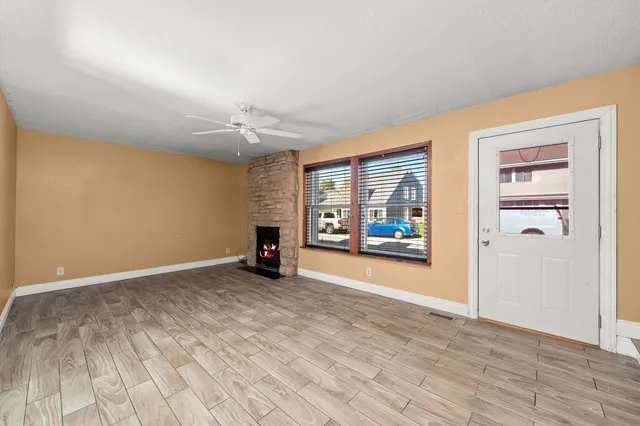 wooden floor in an empty room with a window