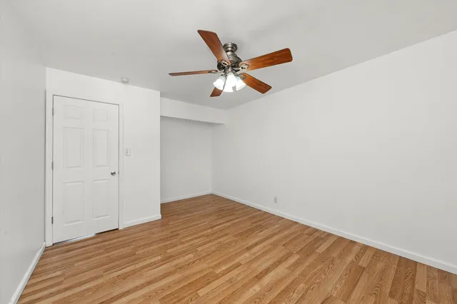 a view of a ceiling fan and wooden floor