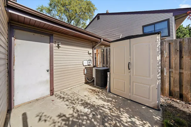 a view of a backyard with plants and wooden fence