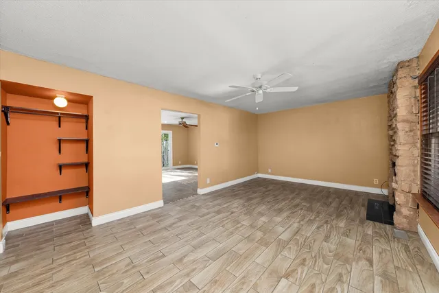 wooden floor in an empty room with a window