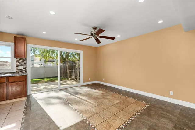 a view of a livingroom with a ceiling fan and window