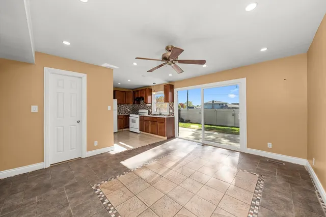 a view of a kitchen with a sink and a refrigerator