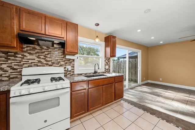 a kitchen with granite countertop cabinets stainless steel appliances and a sink