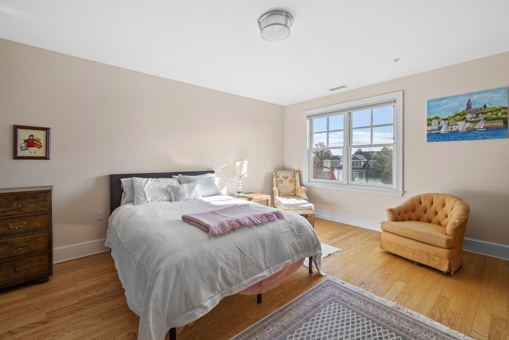 36 Intrepid Circle, Unit 303 Marblehead, MA 01945 - Photo 11 of 22 a spacious bedroom with a bed and a couch