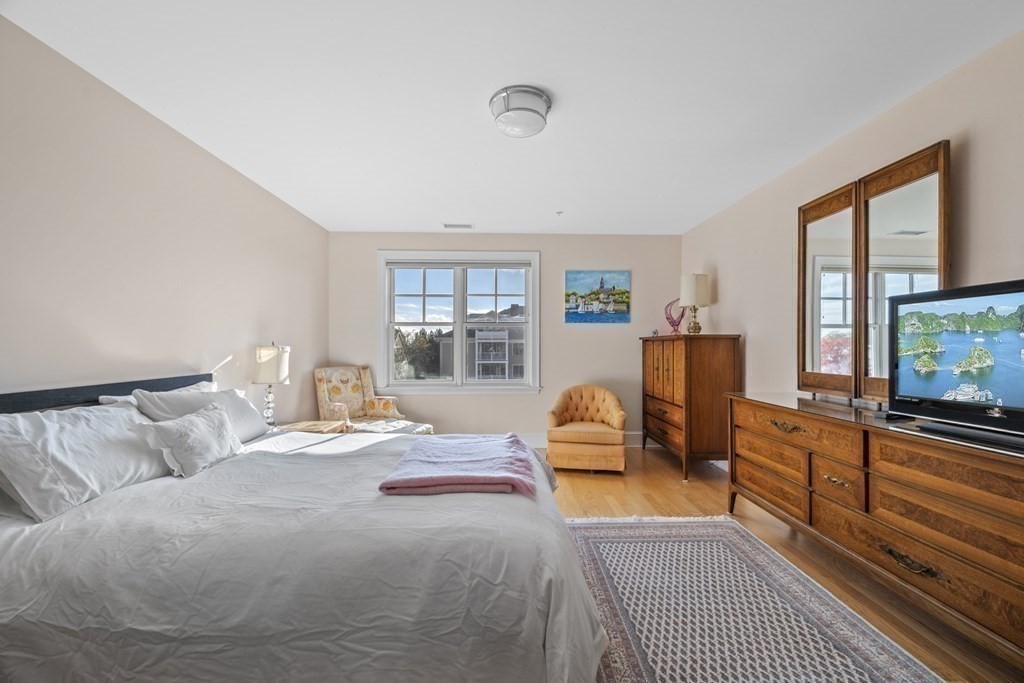 36 Intrepid Circle, Unit 303 Marblehead, MA 01945 - Photo 12 of 22 a bedroom with furniture and a flat screen tv