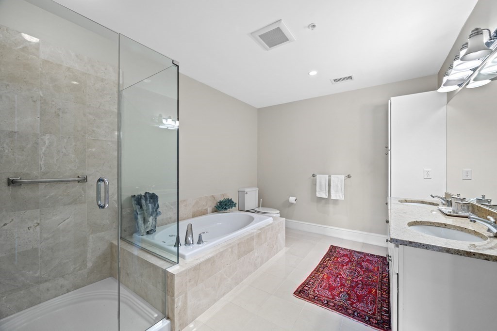 36 Intrepid Circle, Unit 303 Marblehead, MA 01945 - Photo 14 of 22 a spacious bathroom with a tub and shower