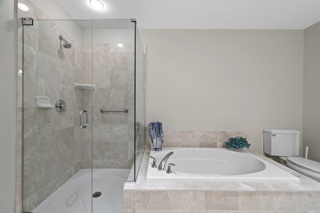 36 Intrepid Circle, Unit 303 Marblehead, MA 01945 - Photo 15 of 22 a white bath tub sitting next to a shower