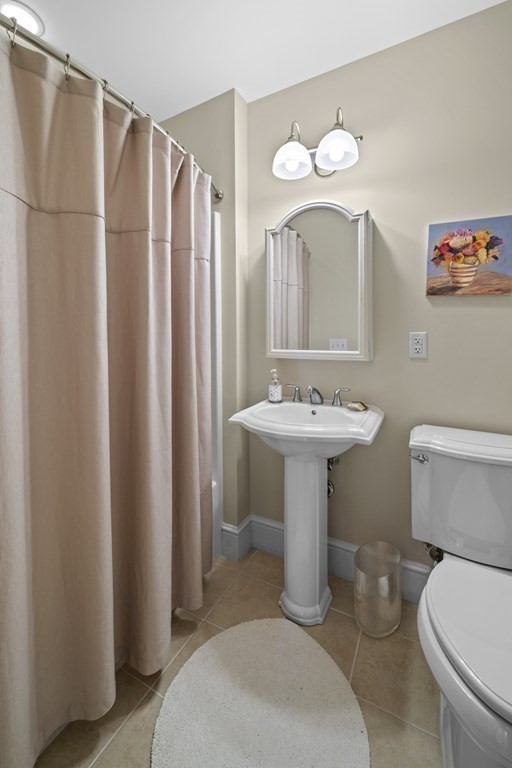 36 Intrepid Circle, Unit 303 Marblehead, MA 01945 - Photo 17 of 22 a bathroom with a sink toilet and a mirror