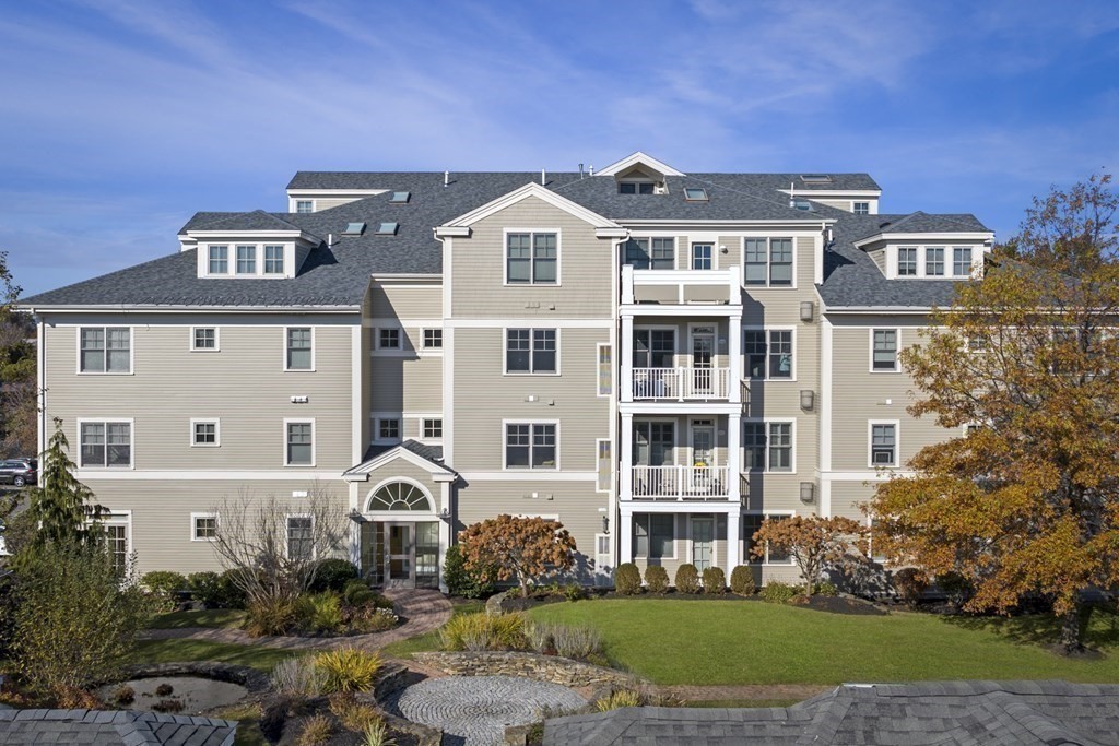 36 Intrepid Circle, Unit 303 Marblehead, MA 01945 - Photo 3 of 22 a front view of a residential apartment building with a yard