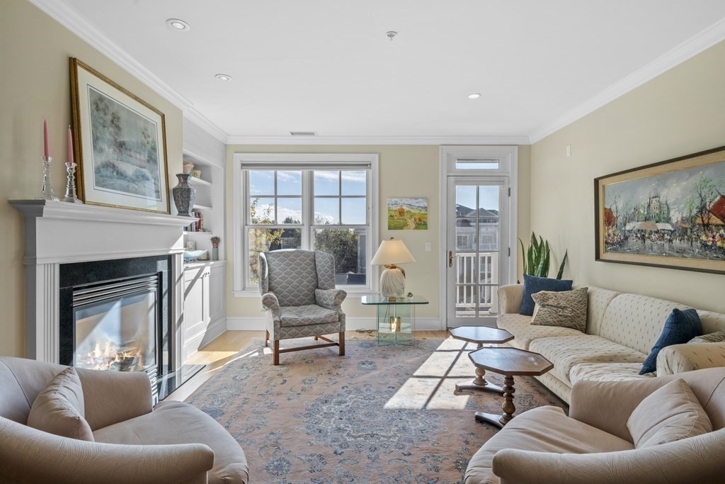 36 Intrepid Circle, Unit 303 Marblehead, MA 01945 - Photo 5 of 22 a living room with furniture a fireplace and a large window