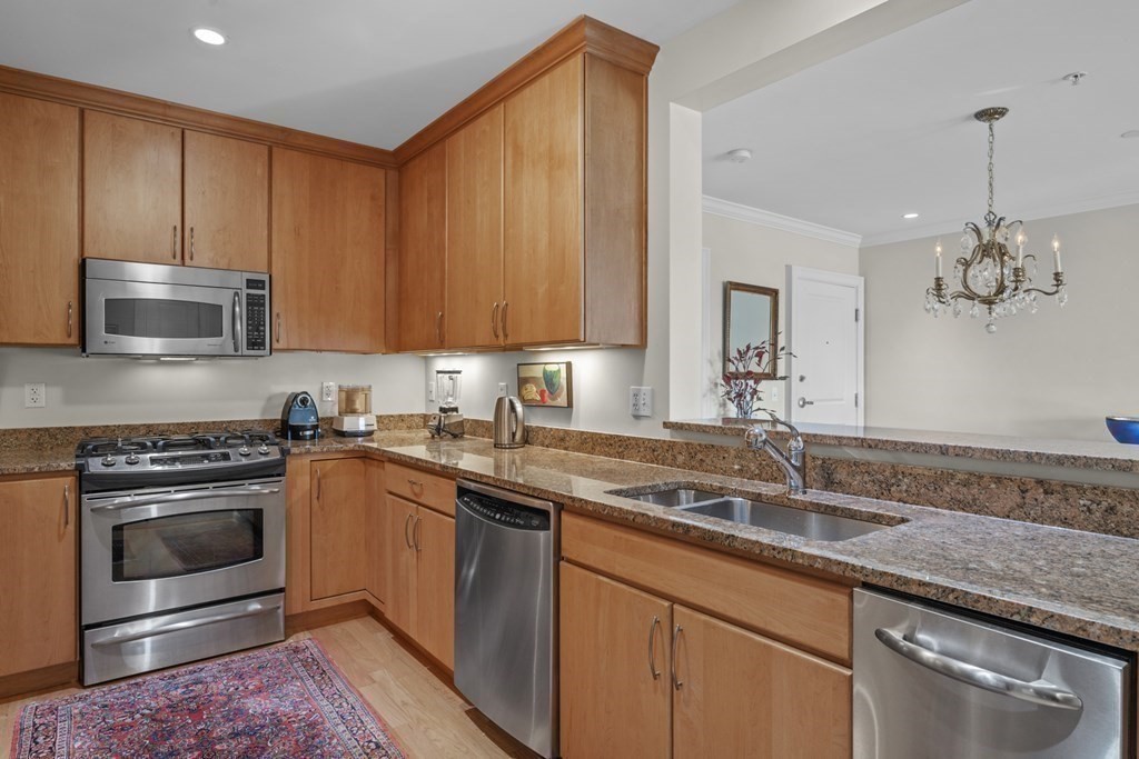 36 Intrepid Circle, Unit 303 Marblehead, MA 01945 - Photo 8 of 22 a kitchen with a sink stove and cabinets