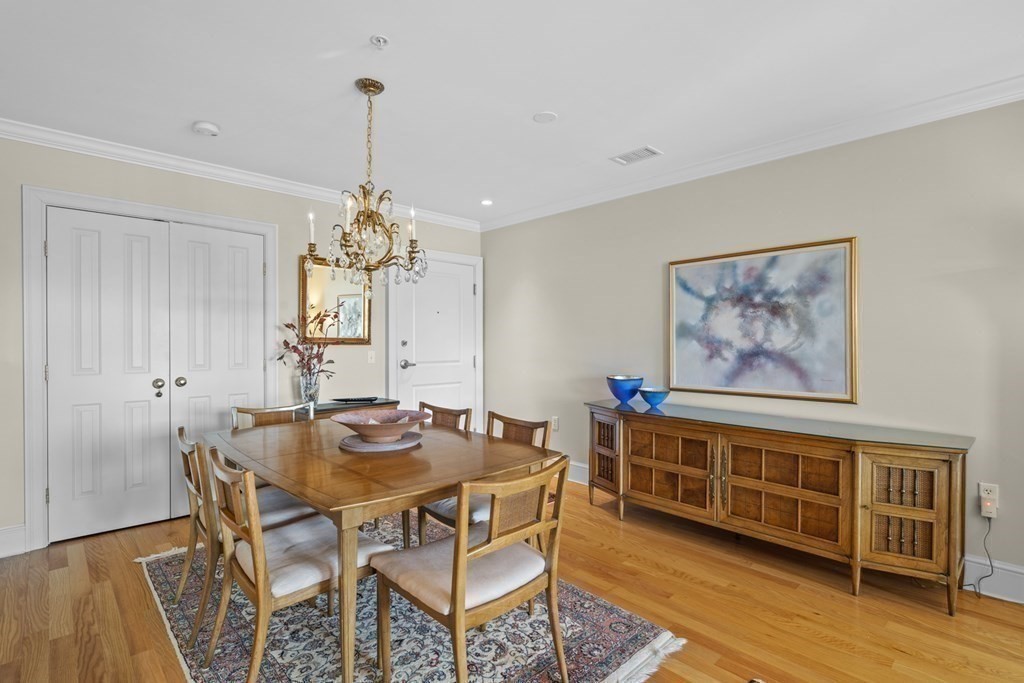 36 Intrepid Circle, Unit 303 Marblehead, MA 01945 - Photo 10 of 22 a dining room with furniture and wooden floor
