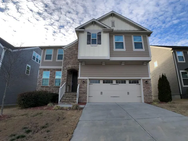 a front view of a house with a yard