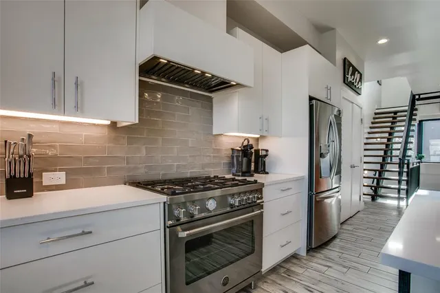 a kitchen with a sink stainless steel appliances and cabinets