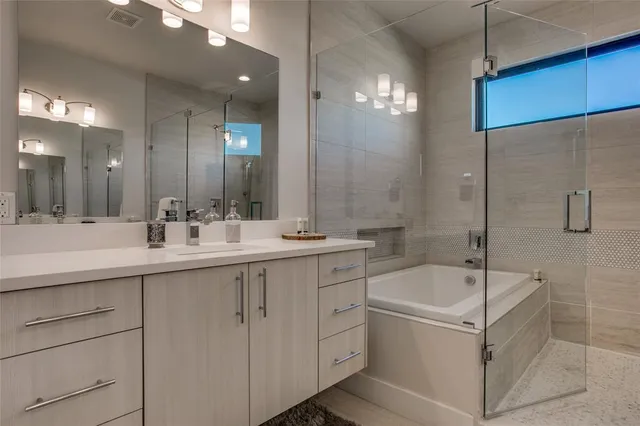 a bedroom with a large bed chandelier and a window