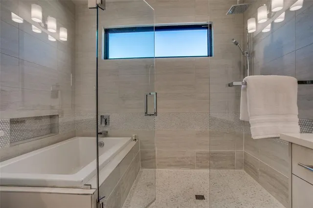 a bathroom with a tub sink and mirror