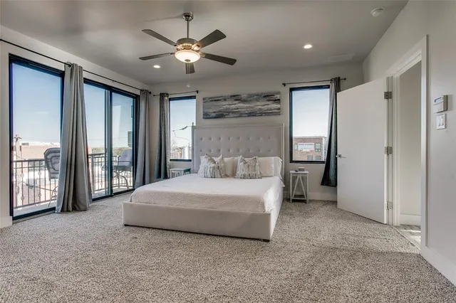 a spacious bedroom with a large bed and a chandelier