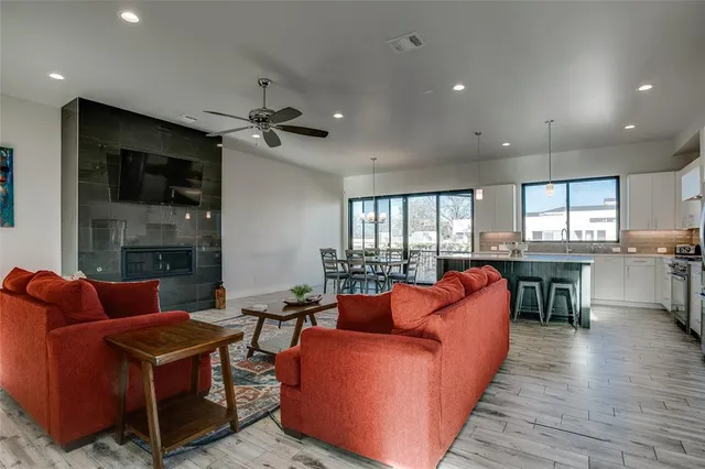 a living room with furniture a fireplace and a flat screen tv