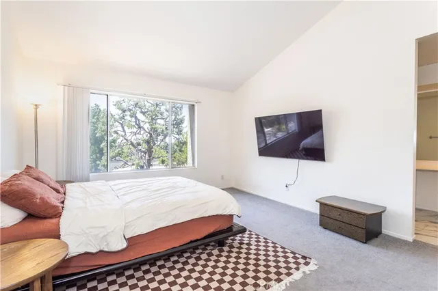 a bedroom with a bed and a couch