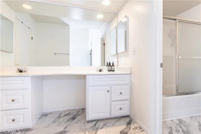 a bathroom with a sink vanity and a mirror
