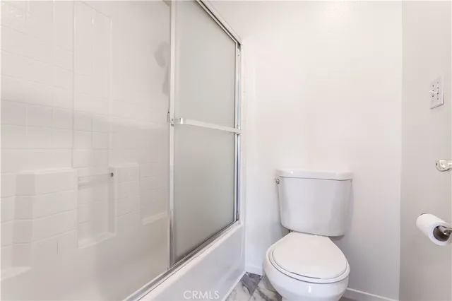 a white toilet sitting next to a bathroom sink