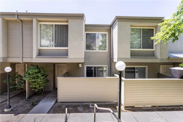 a view of a house with more windows and potted plants