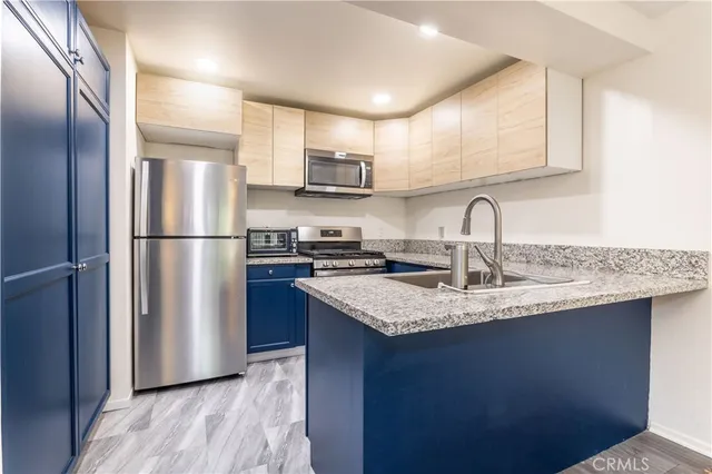 a kitchen with stainless steel appliances granite countertop a refrigerator sink and cabinets